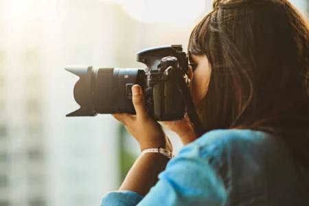 Mulher fotografando pela janela